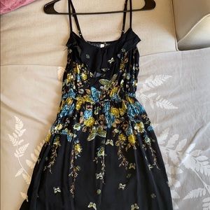 Sleeveless black dress with blue and green